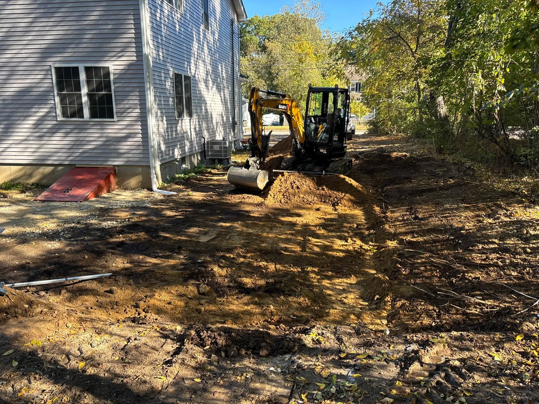 Water pooling near foundation before regrading — Auburn, MA